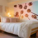 Palm tree dorm room wall art above a bed in a feminine college dorm room