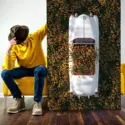 Large hipstoric wall art in white and yellow featuring a vintage car in a field of yellow flowers leans vertically against couch in guys apartment living room
