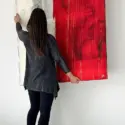 Large Red Abstract Wall Art Being Hung on White Wall