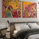 Two Large Warm Colorful Abstract Artworks Hanging Above A Bed