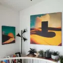 Large desert surreal wall art pairing hangs on white walls in modern office