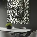 Huge black and white skull wall art made of geometric shapes looks 3D as it hangs on black wall in modern dinning room.