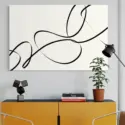Huge line drawing of elegant black lines on white background hangs in modern living room above yellow sideboard