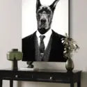 Huge black and white photo of black Great Dane wearing black and white suit hangs above black console table in modern home's entryway