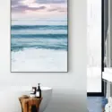Blue wave wall art hangs in bathroom above soaking tub creating a peaceful, spa-like feel.