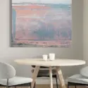 Extra large blue and pink abstract wall art hangs above modern kitchen table.