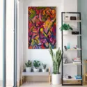 Large contemporary colorful painting hangs above plant shelf next to bookcase on white wall in clean living room.