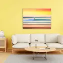 Large contemporary surfing wall art hangs in bright yellow living room