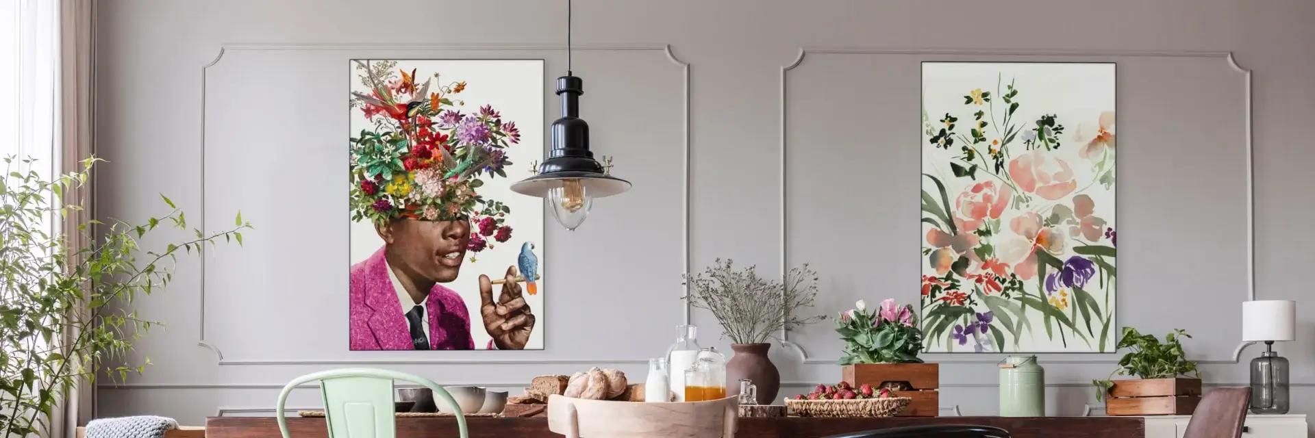 Maximalist dining room with flower wall art featuring "Igor" by BambashkART and "Floral Pink" by Shelby Kregel. Abundance of flowers, mis-matched chairs, colorful vases, and grey paneled walls with two large maximalist flower art pieces; one of a Black man in a pink jacket smoking with a little colorful bird perched on his hand, and the other of a wildflower bouquet in pink, green, and purple.