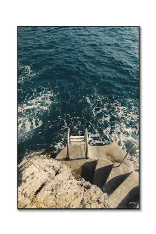 Art print of a metal ladder going into the ocean along the Amalfi coast, shown on a white background.