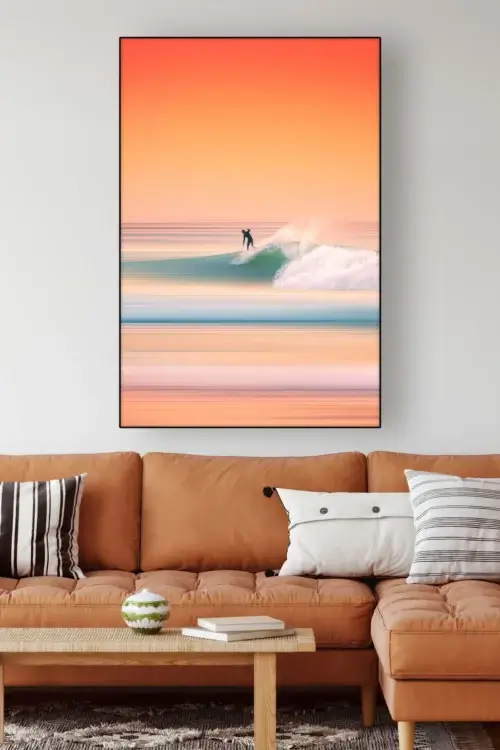 Large photo like surreal summer artwork in shades of oranges and aquas of a lone surfer in a living room