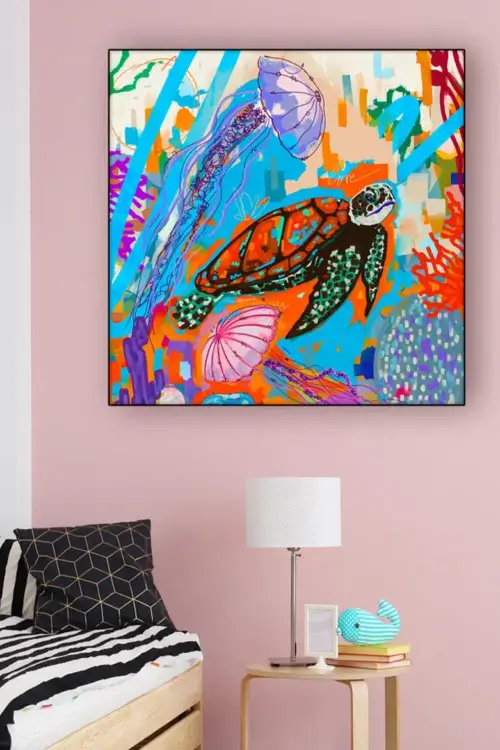 Colorful graffiti style drawing of sea turtle and jellyfish hangs on pink wall in little girls bedroom.