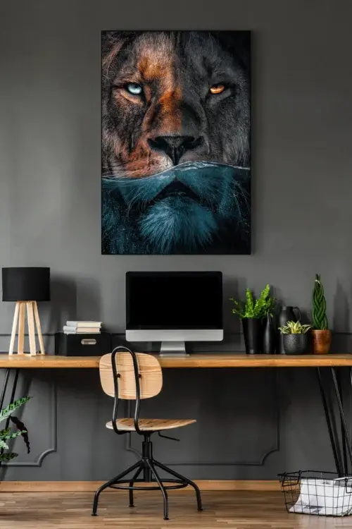 Large lion photo showing lion's face halfway underwater hangs on grey wall in home office.