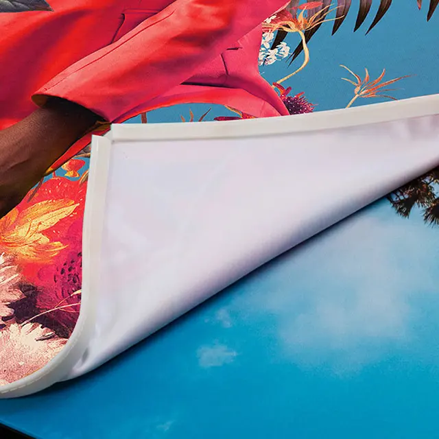Close-up of a high-quality fabric print being easily swapped out of a sleek, swappable frame.