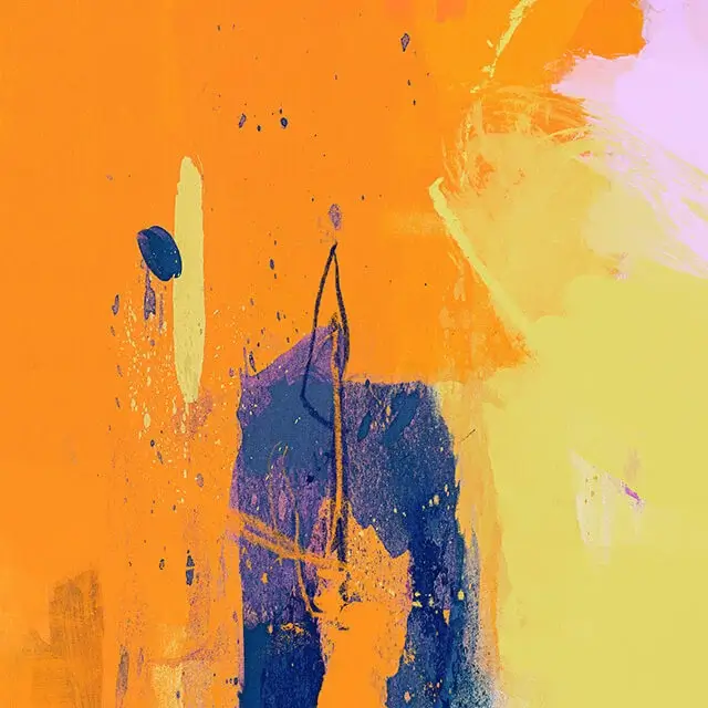 Close up view of yellow blue and orange abstract art. The left half is orange. The right half is yellow. The colors meet in the middle with a patch of dark blue.