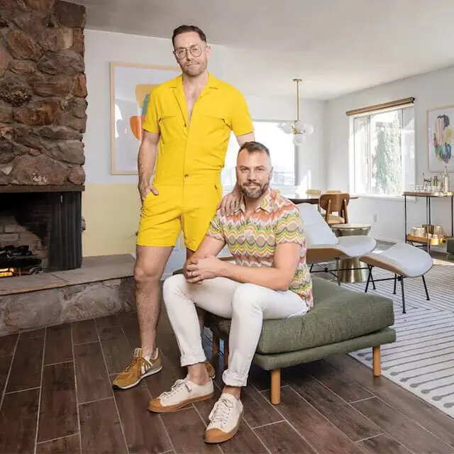 Interior designers and famous actors pose in living room of Joshua Tree Airbnb living room that they just redecorated in luxurious Palm Spring Style
