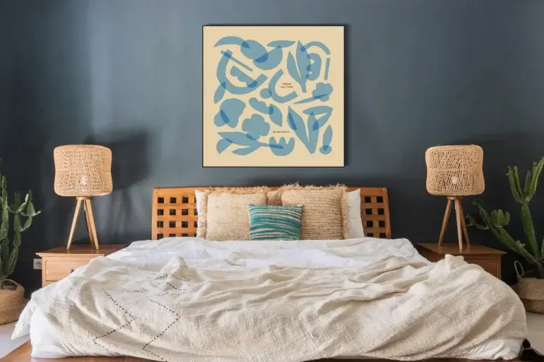 Massive light blue minimal wall art featuring layers of geometric shapes and flowers hangs on whitewashed brick wall above boho bed.