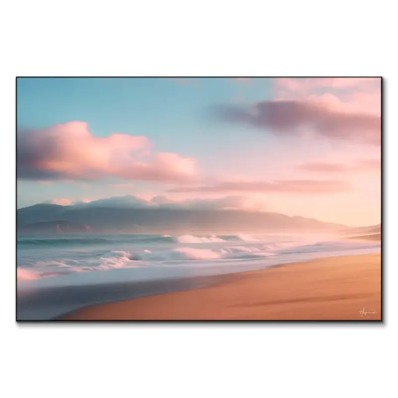 Serene beach at sunrise with gentle waves, pink clouds, and mist-covered mountains.