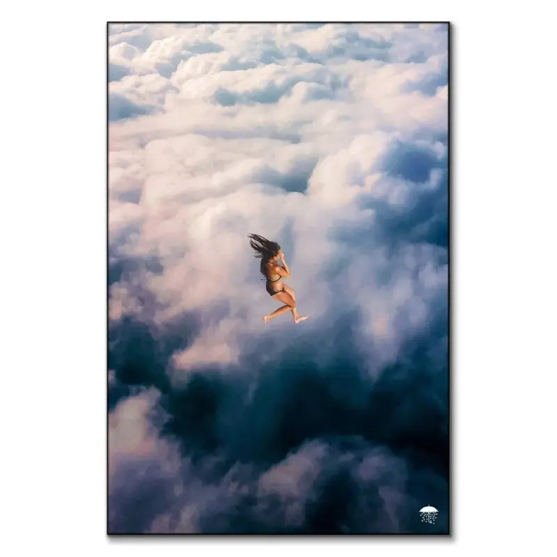Girl in bikini, diving in fluffy white and blue clouds in surreal wall art.