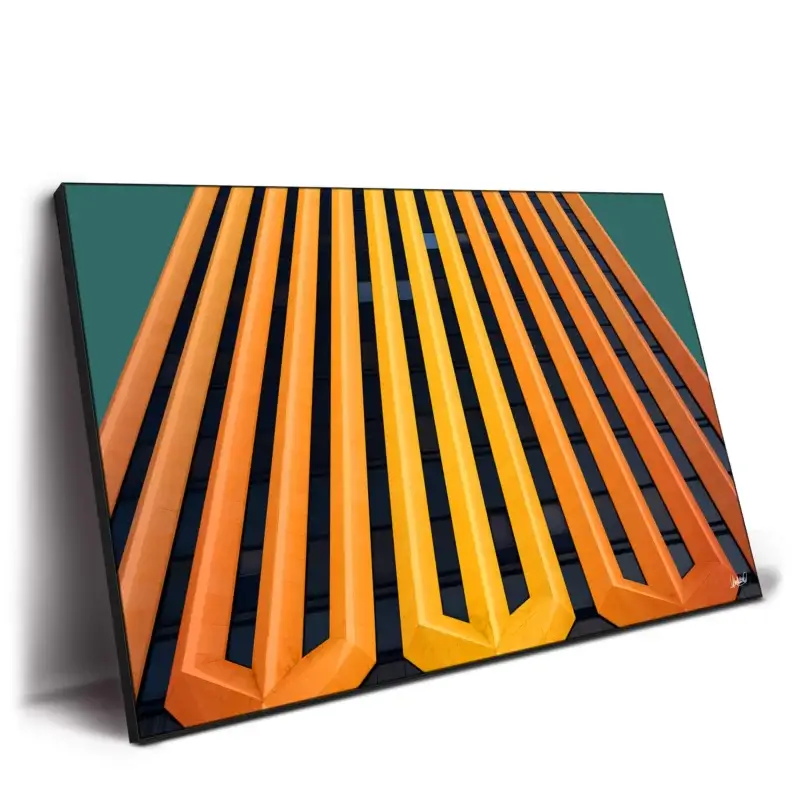 Modern building facade with vertical orange and yellow stripes.