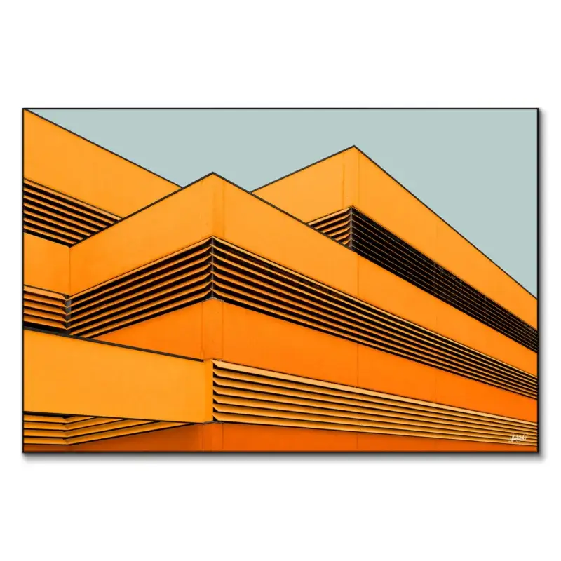 Vibrant building facade with orange panels and black slats in a pattern against a gray-blue background.