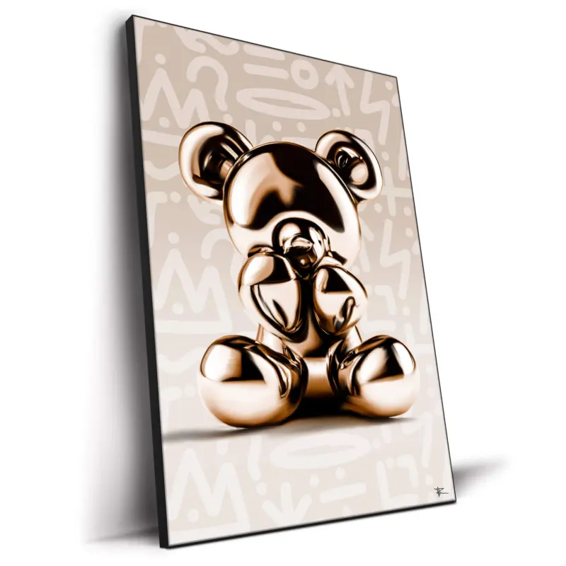 Gold metallic bear sculpture on a graffiti-inspired cream background with abstract patterns.