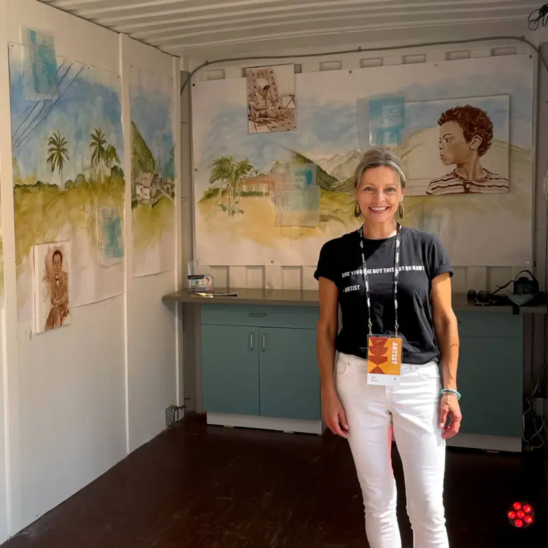 Painter Cary Okoro Stands In Front of Her Blue, Green, and Brown Painted ArtPrize 2022 Exhibit "We Reach Across The Same Blue Sky" on Display in the Muse GR Art Pod.