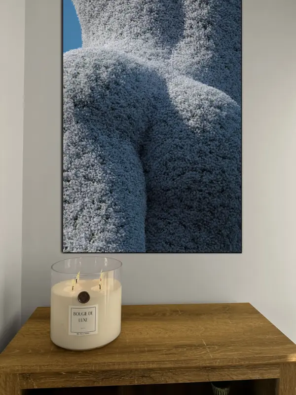 Flowers butt shaped hedge wall art hangs above wooden table with Gardenia Tuberose candle from Big Ass Candle